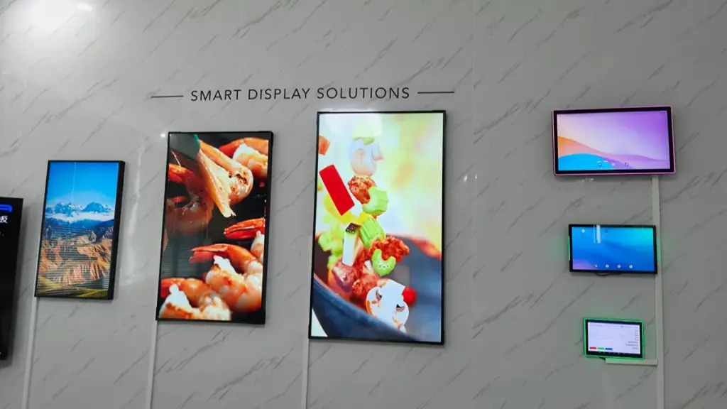 Various wall-mounted smart digital displays showcasing food and scenery images